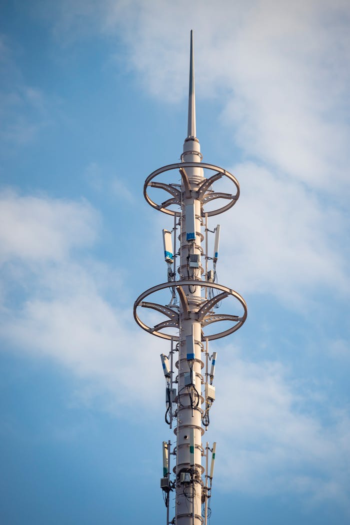 A tall telecommunication tower with antennas under a clear blue sky, symbolizing modern connectivity.